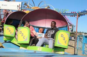 Photo by Luisa Loi
A family has fun spinning at the carnival.