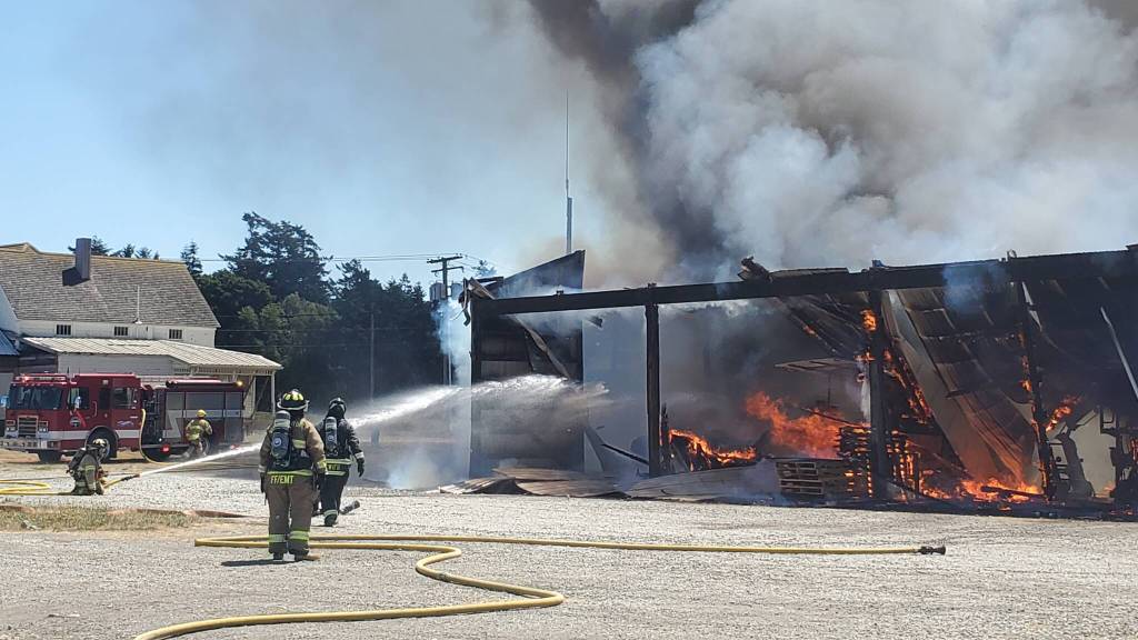 Firefighters attack fire that destroyed the large metal building. (Photo by Luisa Loi)