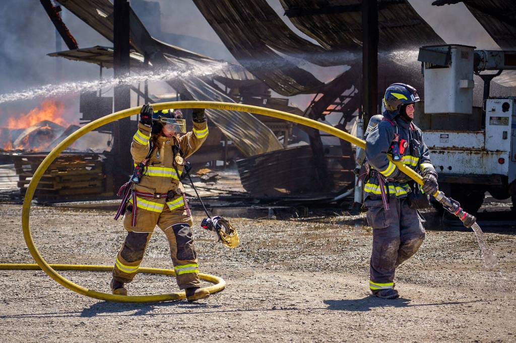 Firefighters with Central Whidbey Island Fire and Rescue fight a fire that destroyed a farm building. (Photo by David Welton)