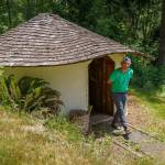 Eli Adadow stands outside of the limpet house, a natural structure made from earth bags. (Photo by David Welton)
