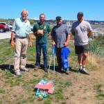 From left, Darwin Christopherson, Washington Department of Fish and Wildlife Biologist Kurt Licence, WDFW Waterfrowl Section Manager Kyle Spragens and Peter Steelquist pose with the wads they collected at Windjammer Park on Aug. 2. (Photo by Luisa Loi/Whidbey News-Times)