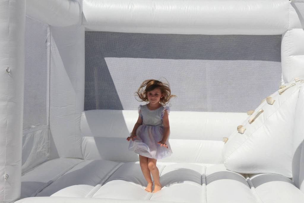 Teagan demonstrates her athletic skills on her favorite inflatable, the Great White. (Photo by Luisa Loi/Whidbey News-Times)