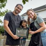 Photo by David Welton
From left, Ansel, Gwen and Sarah Santosa hold the award presented to Ballydidean Farm Sanctuary by the Island County Sheriffs Office.