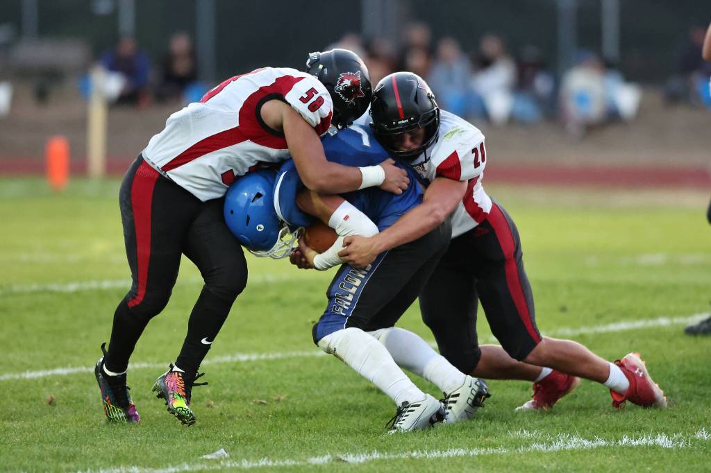 Coupeville players stop a Falcon. (Photo by John Fisken)