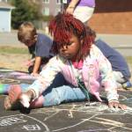 Photo by Karina Andrew/Whidbey News-Times
Kindergartener Taaliyah Holmes helps chalk the walk Sept. 15 at Hillcrest Elementary School.