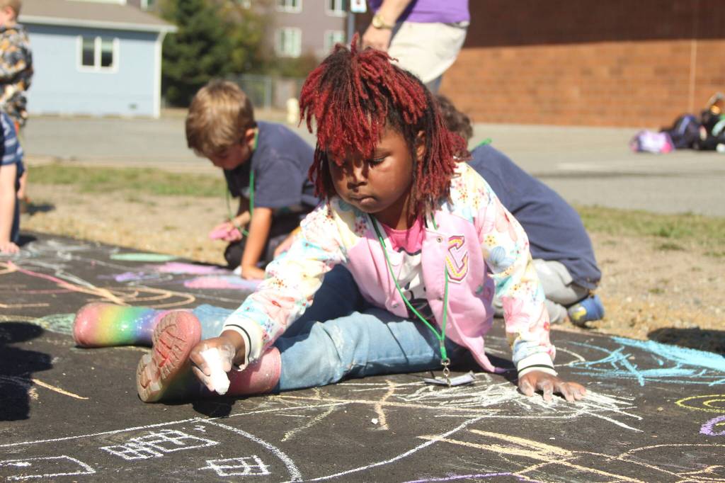 Photo by Karina Andrew/Whidbey News-Times
Kindergartener Taaliyah Holmes helps chalk the walk Sept. 15 at Hillcrest Elementary School.