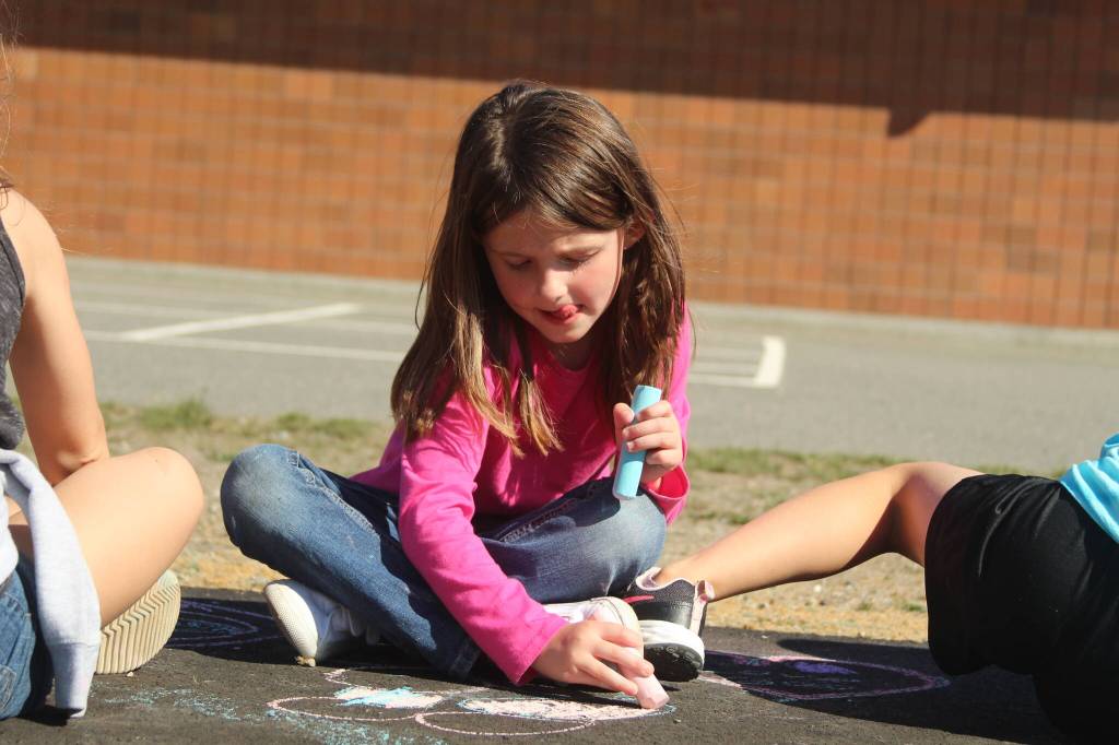 Photo by Karina Andrew/Whidbey News-Times
First grader Maddison Muscutt helps chalk the walk Sept. 15 at Hillcrest Elementary School.