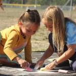 Photo by Karina Andrew/Whidbey News-Times
First graders Isla Stewart, left, and Millie Kindred help chalk the walk Sept. 15 at Hillcrest Elementary School.