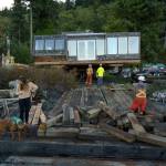 Moving the house from the barge to a truck is a slow-moving process. (Photo by David Welton)