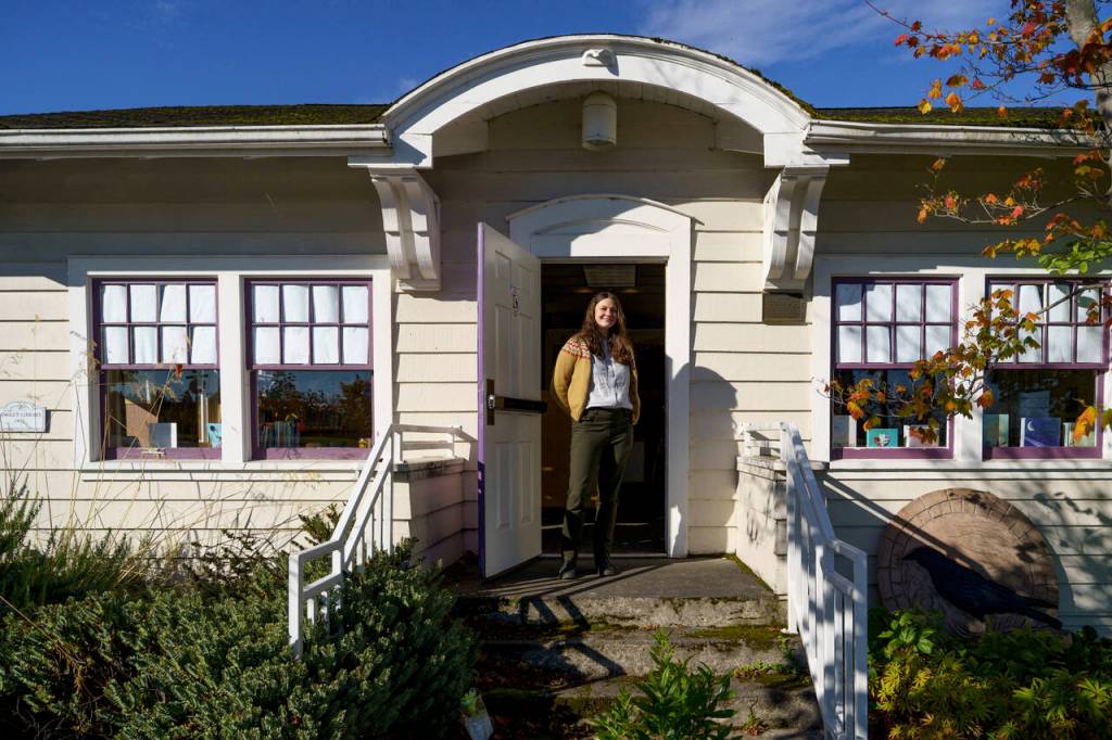 Langley Library Manager Kaley Costello stands in front of the librarys original structure. (Photo by David Welton)