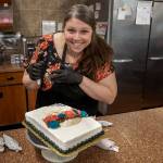 Photo by David Welton
Jennifer Holmes pipes a colorful flower crown for the La Catrina skull on her cake that has a Dia De Los Muertos theme.