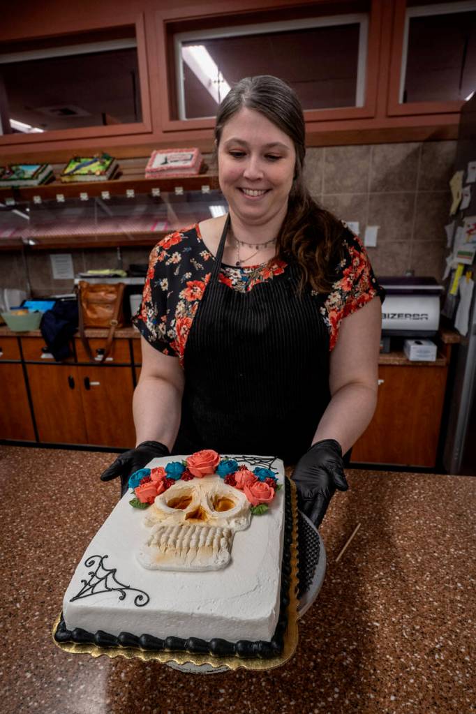 Photo by David Welton
Jennifer Holmes pipes a colorful flower crown for the La Catrina skull on her cake that has a Dia De Los Muertos theme.