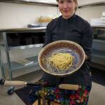 Echo holds a ceramic bowl with her fresh pasta. She will sell pasta bowls created by local artists, as well as pasta rollers, pasta machines and Italian flour. (Photo by David Welton)