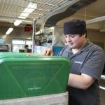 Timmy Aston dries off trays at the bases galley after sharing his extensive knowledge on video games and cartoons. (Photo by Luisa Loi)