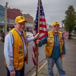 Tom Bond and Doug Jerome install a flag. (Photo by David Welton)