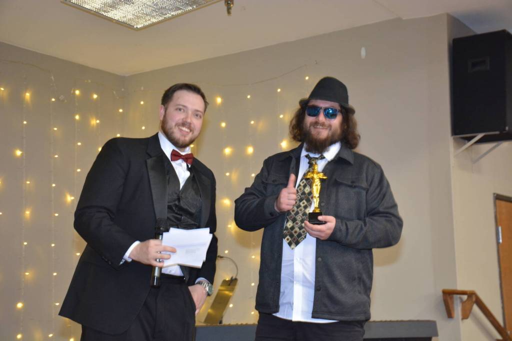 Whidbey News-Times Wesley Moran presents a trophy to Jared at Off the Hook, who won Best Bartender. (Photo by Megan Yerton)