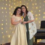 Whidbey News-Times Samanthajoy Fatlan presents a trophy to Marri Metz for Best Party Rental. (Photo by Megan Yerton)