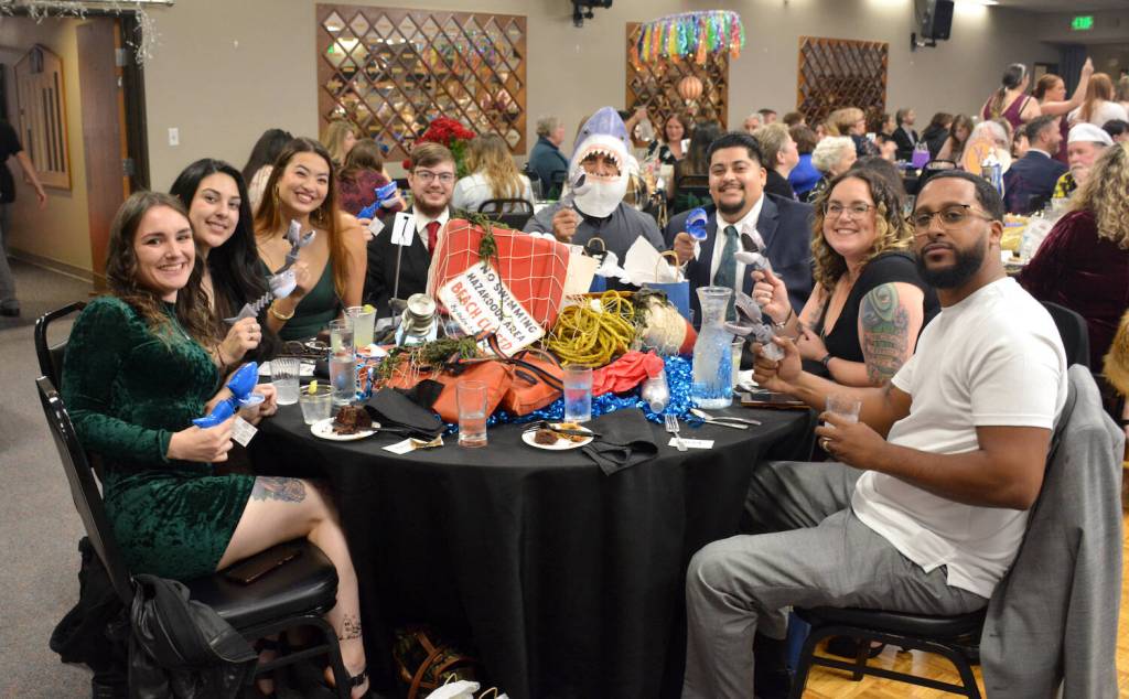 Staff at the Green Room in Oak Harbor sit at a Jaws-inspired table during the Best of Whidbey Gala at the Elks Lodge on Nov. 2. Winners of the annual best of contest were announced during the fun-filled night. The event had a Hollywood theme this year and each table was decorated for a different movie, including Ghost Busters, Forrest Gump, Star Wars and Breakfast at Tiffanys. The Green Room won Best Cannabis Store. (Photo by Megan Yerton)