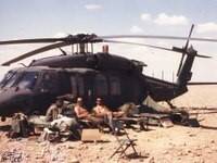 Men rest by an aircraft in Iraq. (Photo by Bill Frost)