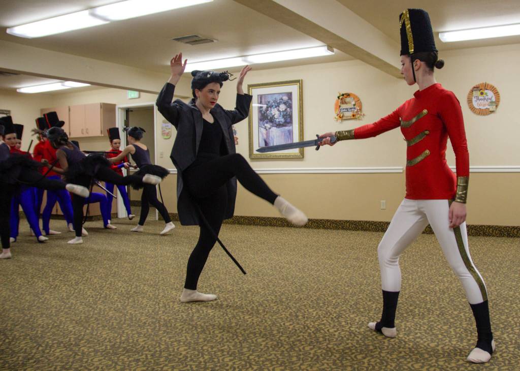 The Nutcracker, performed by Riley White, faces the Rat King, played by Lily Brinlee. (Photo by Luisa Loi)