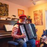 David Locke plays the accordion at his house in Langley. One of the most common compliments he hears is that his performances feel like Paris. (Photo by Luisa Loi)