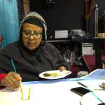 Pastor Dean paints the background for her drive-through Nativity Scene. (Photo by Luisa Loi)