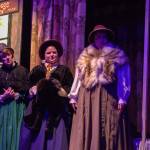 The four madrigals (played by Allenda Jenkins, Geri Thomas, Ellie Alexander and Susan Larsen) watch Scrooge act unpleasantly. (Photo by Luisa Loi)