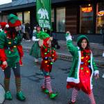 The Tipsy Jellifishs elves parade on Pioneer Way on Dec. 2. (Photo by Luisa Loi)