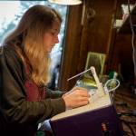 Bennett grinds a piece of stained glass. (Photo by David Welton)