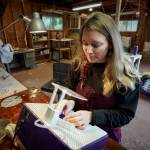 Bennett grinds a piece of stained glass. (Photo by David Welton)