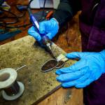 Mackensie Bennett solders a glass morel mushroom in her workshop. (Photo by David Welton)