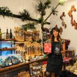 Juliana Uluave-Gould, owner of PNW Vibes, holds Coupeville Coffee Roasters Rustic Pacific Northwest Blend while surrounded by the art provided by her store. (Photo by Luisa Loi)