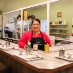 Megan Varner-Duckett, owner of Varner Candle Company, stands behind the bar where guests can enjoy a drink and craft their own candles. (Photo by Luisa Loi)