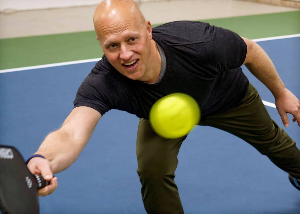 Paul Tschetter has his eye on the pickleball. (Photo by David Welton)