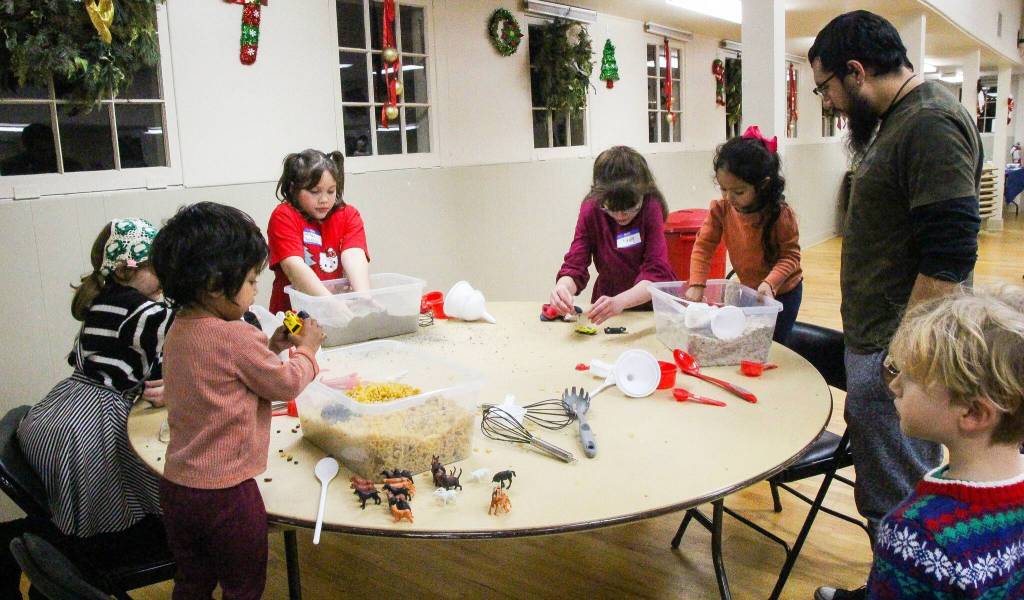 A group of children play at the Coupeville Recreation Hall on Dec. 20. Parent to Parent Coordinator Tiffany Wheeler Thompson said some families have been involved with the organization for many years. Parent to Parent hosts dance parties, sensory-friendly movie nights and bowling games that are organized with special need children in mind but are open to anyone. (Photo by Luisa Loi)