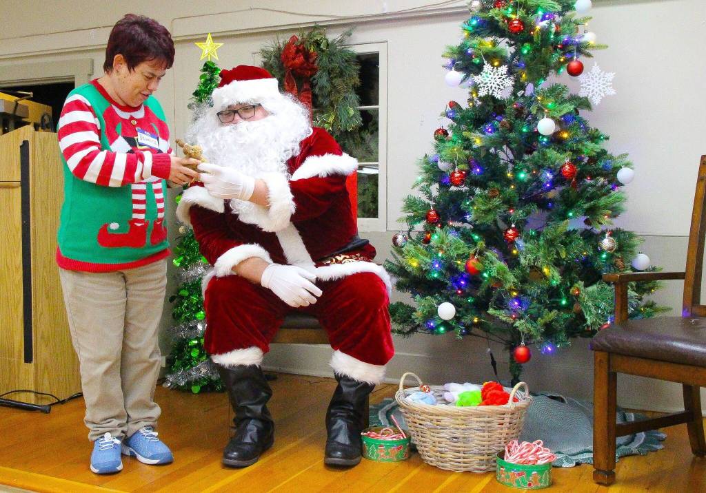 This guest at the Parent to Parent Holiday Family Fun event made it to Santas good list. Every year, Island County Parent to Parent hosts this special needs-friendly celebration. Tiffany Wheeler Thompson, who coordinated the event, said that Santas are often not prepared to interact with special needs children. Because of that, Parent to Parent brought a Santa who has experience with these kiddos. (Photo by Luisa Loi)