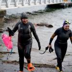 Sharon Emerson and Kate Poss exit from their morning swim at the Langley marina. (Photo by David Welton)