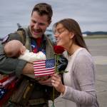 Scott Waitley greets his wife, Maggie, and 2-month-old son, Warren, after returning home from deployment in April. (Photo by David Welton)