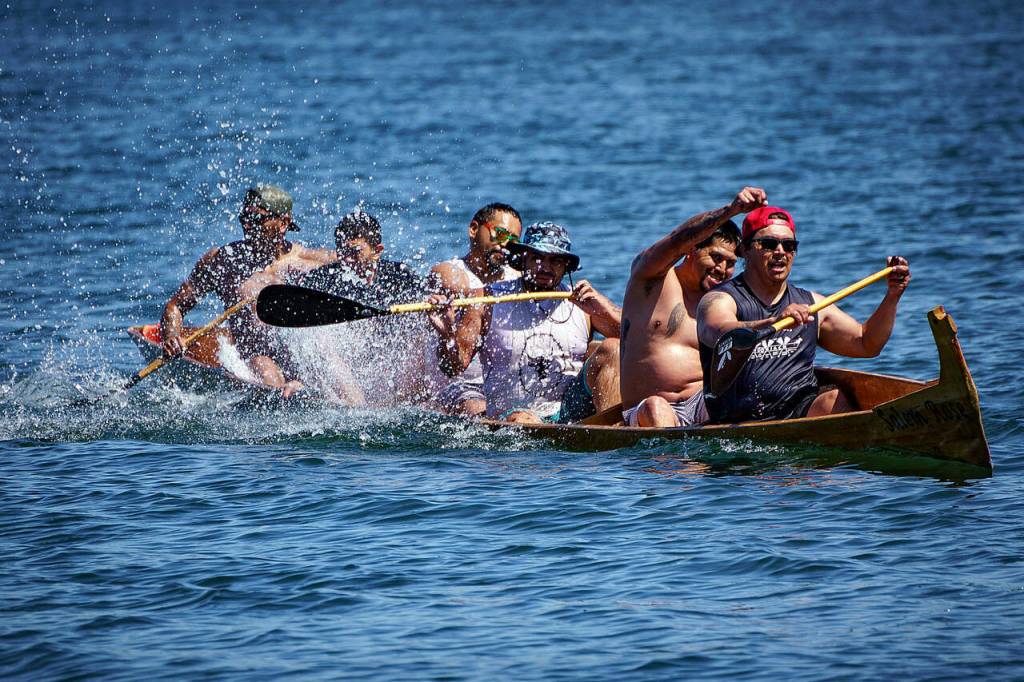 Members of various Coast Salish tribes participate in canoe races at the Penn Cove Water Festival May 13. This years festival was the first since the beginning of the COVID-19 pandemic to hold the traditional canoe races. (Photo by David Welton)
