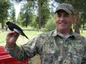 Photo of Jeff Kozma with white-headed male woodpecker
