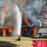 Firefighters from South Whidbey Fire/EMS practice extinguishing a blaze during a training session. The fire district is planning to ask voters to approve a levy lid lift in 2024 to fund the hiring of more personnel and the replacement of aging equipment. (Photo by Karley Diffie)