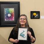 Scribner holds one of her whimsical pieces depicting Nessie. (Photo by Luisa Loi)
