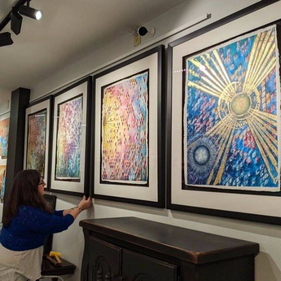 Scribner adjustes one of her framed art pieces. (Photo provided)