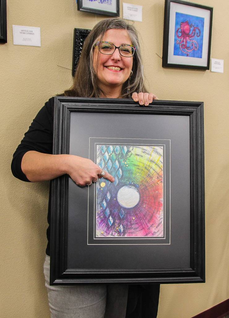 Tiffany Scribner holds Happy Traveler while pointing at the ant. (Photo by Luisa Loi)