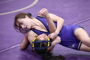 Photo by John Fisken
Oak Harbor’s Julia Gonzales tries to pin an opponent during a match Saturday during the Rock Island Rumble tournament Saturday that saw 13 schools compete at Oak Harbor High School. Gonzales placed first in the 100-pound weight class.