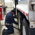 On January 18, 2024, Public Works Department mechanic Joe Ramirez installs chains on the tires of the Citys garbage trucks during a snowstorm. (Photo courtesy of City of Oak Harbor Public Works)