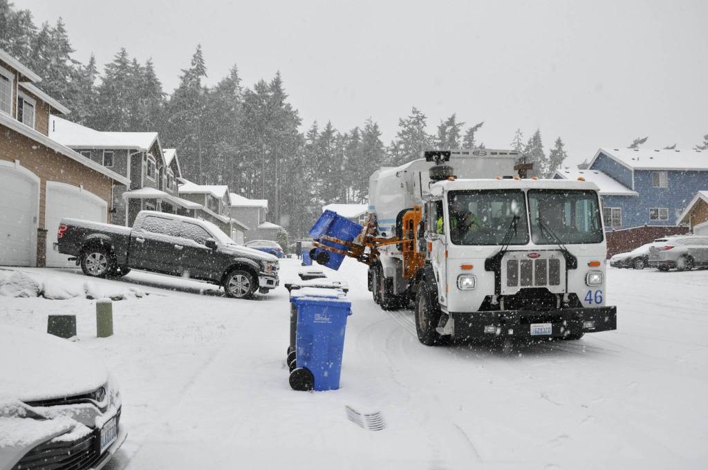 On January 18, 2024, Public Works Department staff George Place collects garbage and recycling from homes in Oak Harbor during the start of a snowstorm. (Photo courtesy of City of Oak Harbor Public Works)