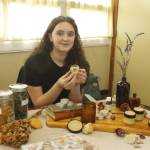 Tenth grader Alicia Jenkins made lemon balm lip balm, a salve for minor abrasions and a candle of orange and bergamot. (Photo by Kira Erickson/South Whidbey Record)