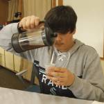 Ninth grader Liam Akhtar pours a tea of elderberry, chamomile and tulsi that he brewed. (Photo by Kira Erickson/South Whidbey Record)