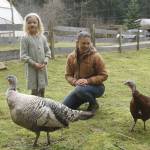 Saoirse Dunham, 6, with mother Jenny Goff and turkeys Silver and Lilac. (Photo by Kira Erickson/South Whidbey Record)